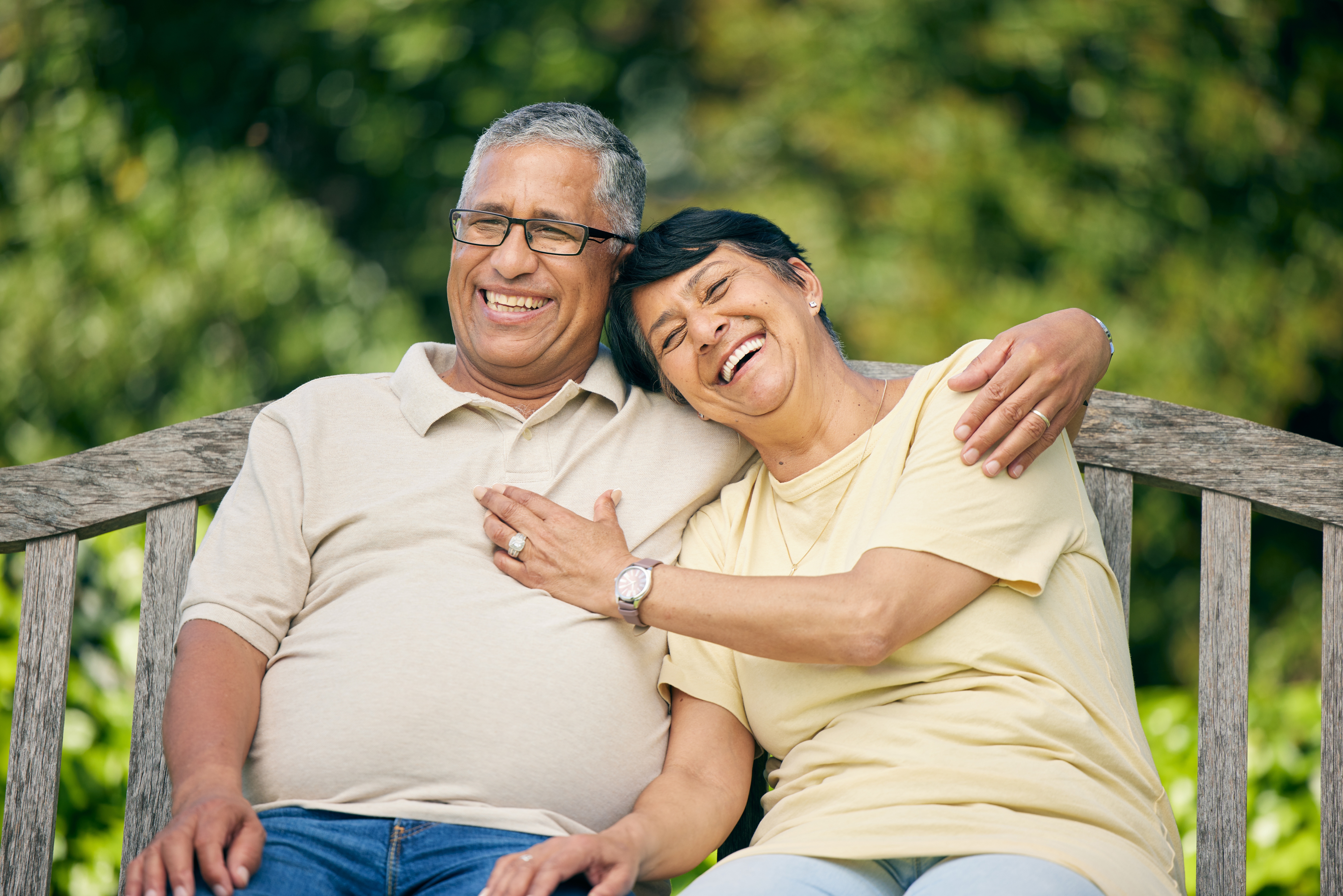 Retired couple relaxing together on a park bench